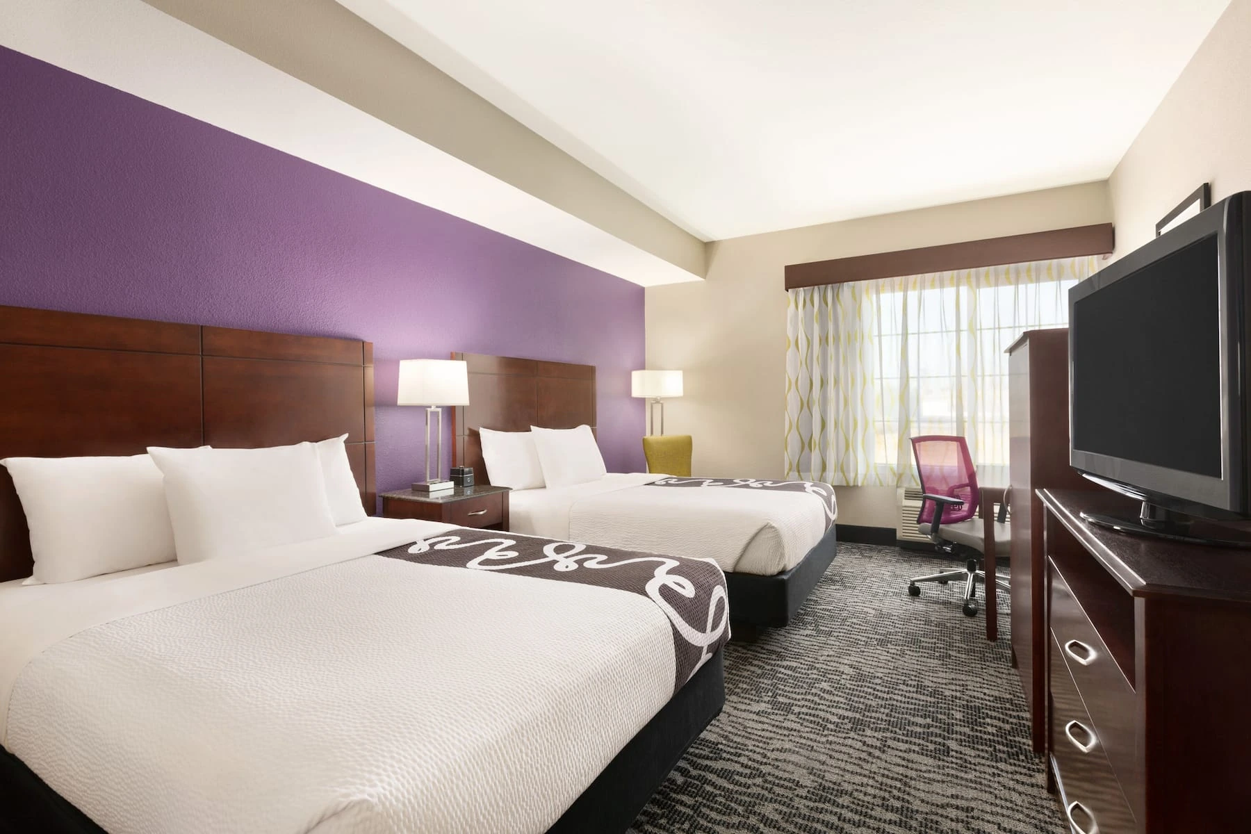 Spacious guest room with bed and television